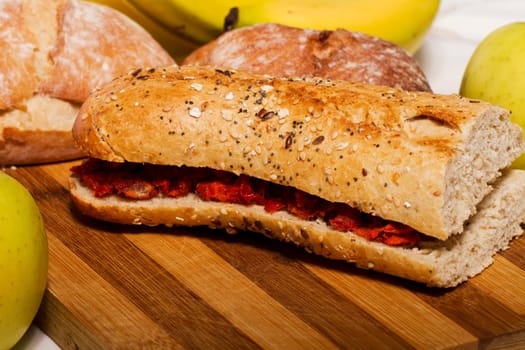 View of a dish of fresh sandwich with seeds filled with Portuguese chorizo.