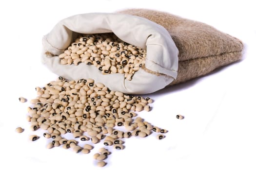 View of a sack of black eyed peas beans isolated on a white background.
