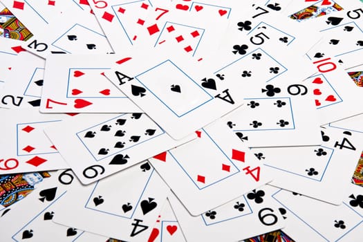 Close up view of a bunch cards spread on a green cloth table.