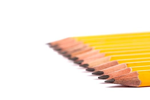 Close up view of a bunch of yellow pencils isolated on a white background.