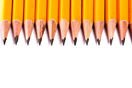 Close up view of a bunch of yellow pencils isolated on a white background.