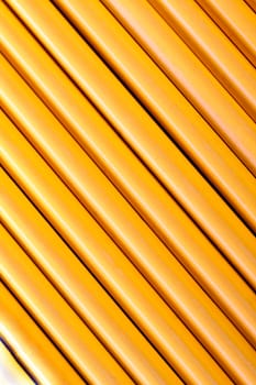 Close up view of a bunch of yellow pencils isolated on a white background.