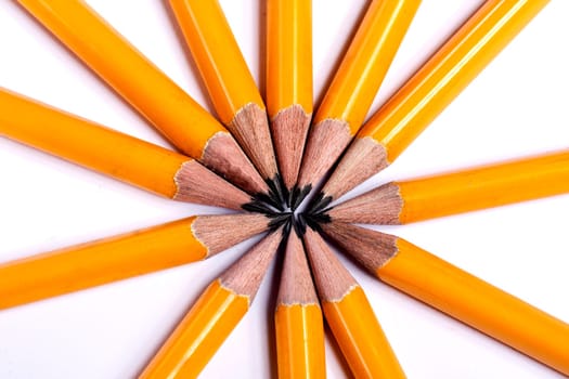 Close up view of a bunch of yellow pencils isolated on a white background.