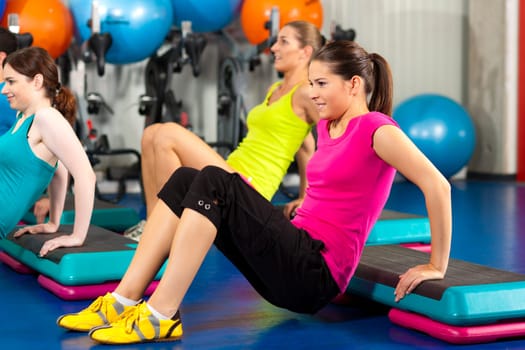 People in gym with step board