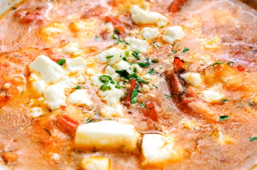 Baked feta cheese with hot salsa sauce with salad