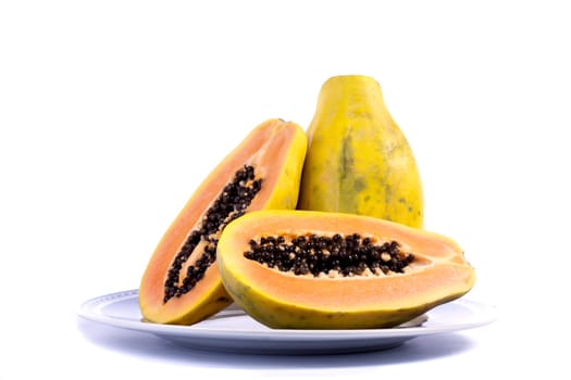 Close up view of papaya fruit sliced presented on a dish.