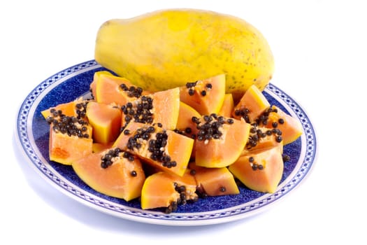 Close up view of papaya fruit sliced presented on a dish.