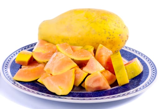 Close up view of papaya fruit sliced presented on a dish.