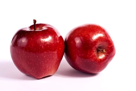 Close up view of some red apples isolated on a white background.