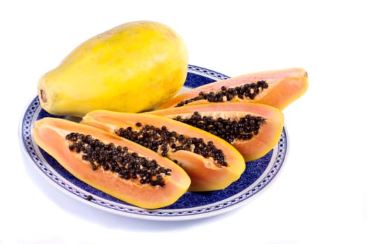 Close up view of papaya fruit sliced presented on a dish.