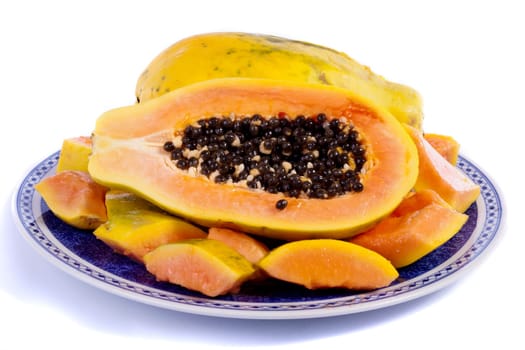 Close up view of papaya fruit sliced presented on a dish.