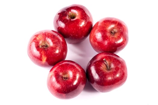 Close up view of some red apples isolated on a white background.