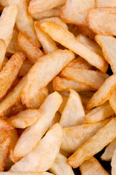 Close up view of a bunch of fried potatoes in slices.