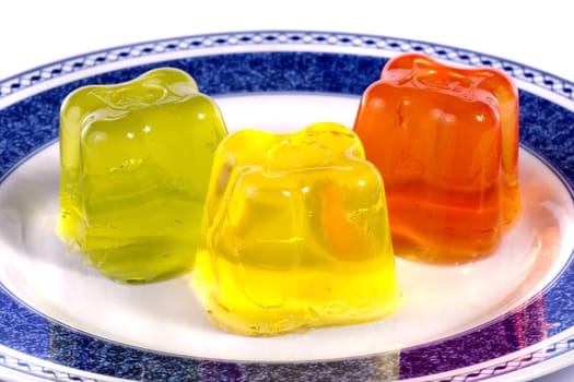Close up view of several colorful gelatins isolated on a white background.