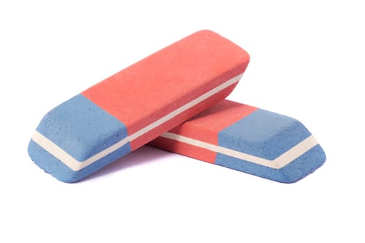 Close up view of a blue and red eraser isolated on a white background.