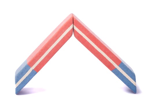 Close up view of a blue and red eraser isolated on a white background.