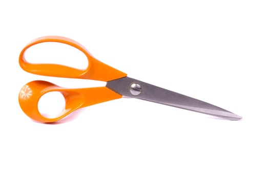 Close up view of an orange scissor isolated on a white background.