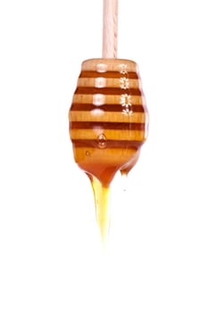 Close up view of a glass of honey and another of chocolate with cookie rolls.