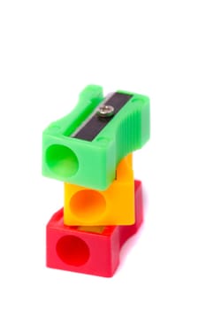 Close up view of three pencil sharpeners isolated on a white background.
