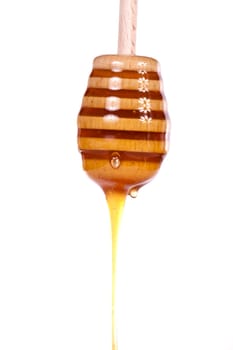 Close up view of a glass of honey and another of chocolate with cookie rolls.