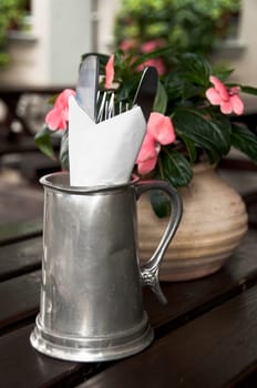 Cutlery in a zinc jar in a British pub