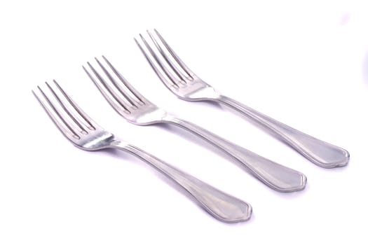 Close up view detail of some forks isolated on a white background.