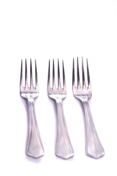 Close up view detail of some forks isolated on a white background.
