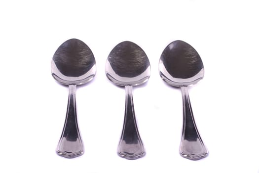 Close up view detail of some spoons isolated on a white background.