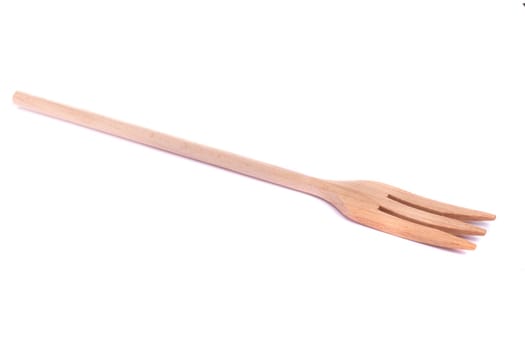 Close view detail of a kitchen wooden fork isolated on a white background.