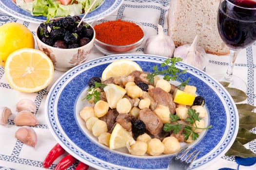 Close up view of a Portuguese meal of cooked meat with potatoes.