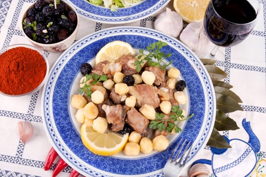 Close up view of a Portuguese meal of cooked meat with potatoes.