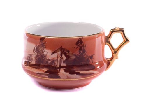 Close up view of an old retro mug for drinking tea isolated on a white background.