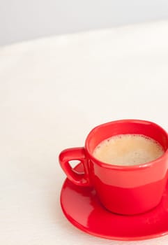 Espresso Coffee in Red Cup on Light Tablecloth