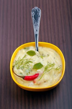 Freshly prepared indian curry garnished with curry leaves and coriander leaves