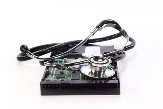 a hard drive and stethoscope voe white background