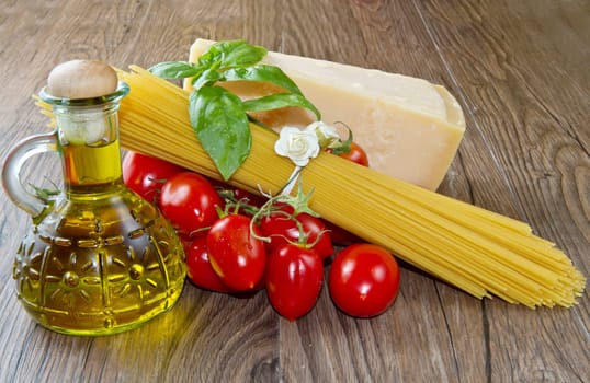 spaghetti ingredients with fresh tomatoes, basil and parmesan cheese