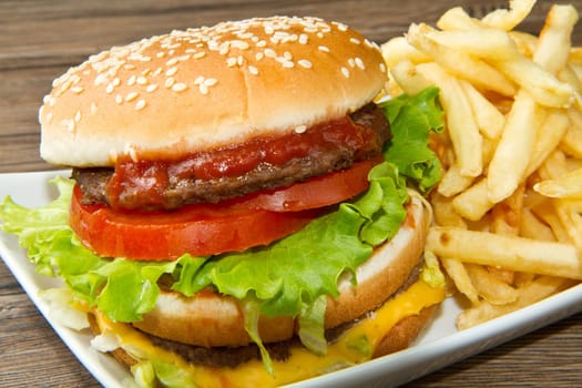 hamburger with potatoes on wooden background