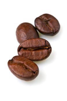 macro shot of coffee beans isolated on white background