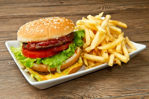hamburger with potatoes on wooden background