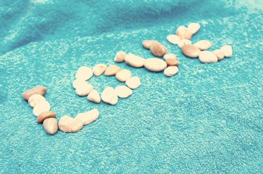Love Sign Made of Pebbles on Blue Towel - Vintage Look