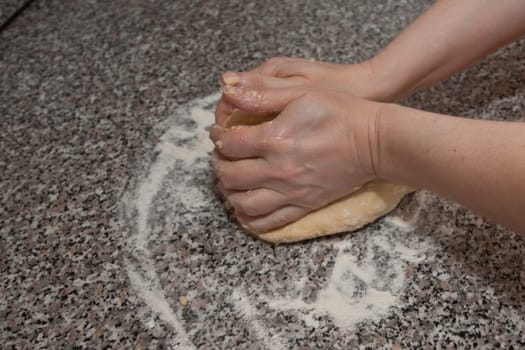 Two hands kneading a dough
