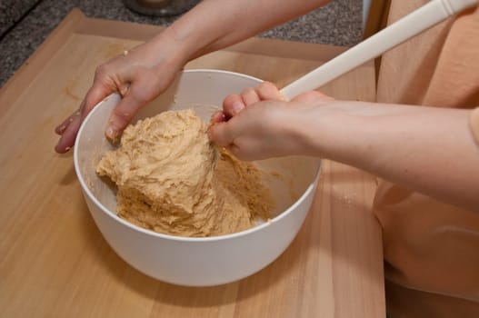 Yeast dough is stirred with a mixing spoon