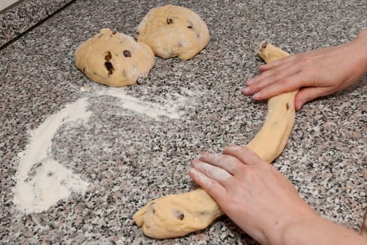 A yeast dough is rolled into a yeast braid