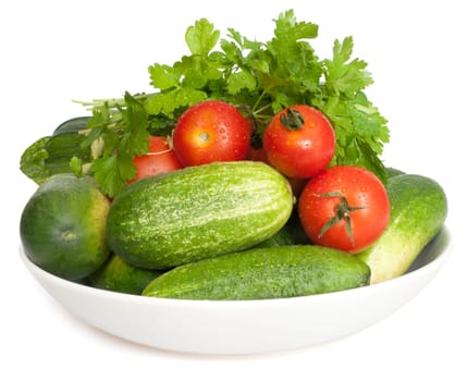 Fresh Vegetables on Plate on White Background - Tomatoes, Cucumbers, Zucchinis and Parsley