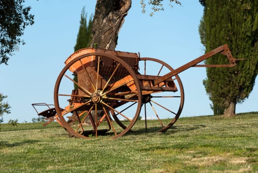Old plow in a field show up in Tuscany