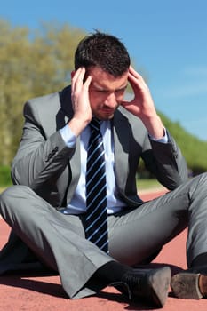 young businessman with head in the hands