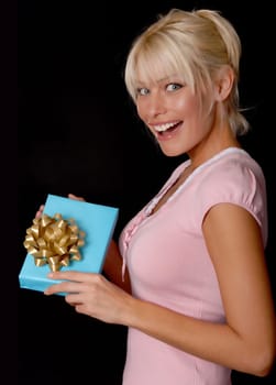 Beautiful young girl holding a wrapped package