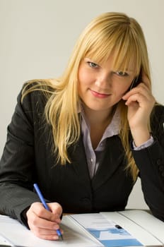 Young woman in office talking on the phone