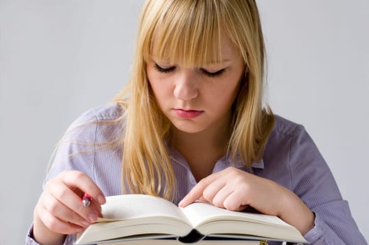 Young attractive woman learning with books
