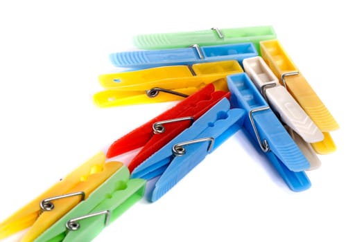Close up view of some colorful cloth pegs isolated on a white background.